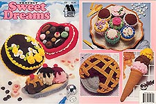 Annie's Attic Crochet Sweet Dreams contains patterns for crochet Chocolate Cake, Ice Cream Cone, Box of Candy, Blackberry Pie, Banana Split, and Plate of Cupcakes.